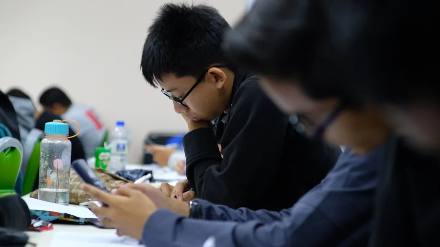 Add Maths students working at their desks during a class in Shah Alam